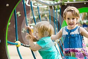 Two cute little sisters at playground