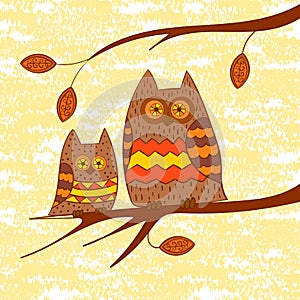 Two cute owls on the branch.