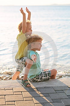 Two cute red curly boys brothers play pretend as they are flying