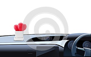 Two cute red hearts in a white square ceramic pot on car console. Car console, steering wheel inside the car with white background