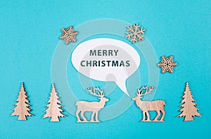 Two cute reindeers talking to each other, speech bubble with merrychristmas greetings, blue colored background
