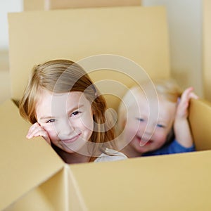 Two cute sisters moving in her new home