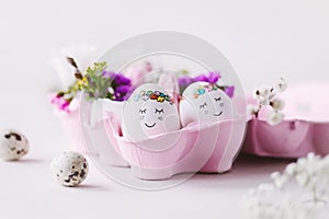 Two cute sleeping Eastereggs in a pink egg box with beautiful flower decoration