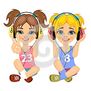 Two cute teenager girls sitting together on floor listening music with headphones