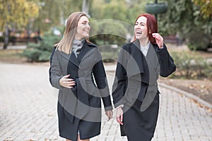 Two cute young girls are walking and talking about important topics.