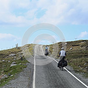 Two cyclist cycling uphill