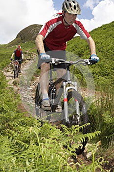 Two Cyclists On Countryside Track