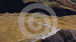 Two Cyclists Cycling in the Mountains. Italian Alps, Italy. Aerial View