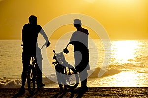 Two cyclists front the sea