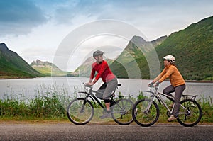 Two cyclists relax biking