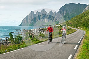 Two cyclists relax biking