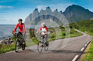 Two cyclists relax biking