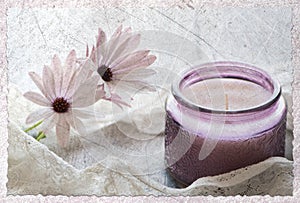 Two Daisies rapped in lace with purple candle on grungy background