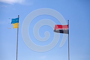 Two damaged flags by Ukraine and by Arms of Ukrainian Nationali