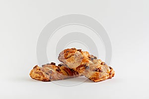 Two Danish maple pecan plaits pastry on a white background with copy space