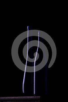 Two dark blue bottles on a black background