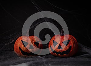 Two dark pumpkin halloween in black background