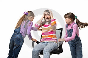 Two daughters unwind mom in an office chair