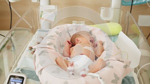 Two-day-old newborn baby in intensive care unit in a medical incubator. Newborn rescue concept. Premature newborn baby