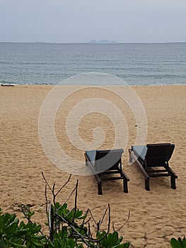 Two deck chairs on the beach