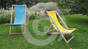 two deck chairs in grass