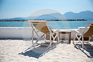 Two Deckchairs and sun loungers on beach