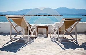 Two Deckchairs and sun loungers on beach