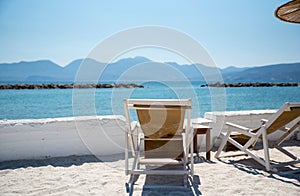 Two Deckchairs Under Parasol