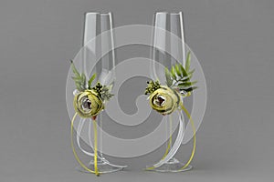 Two decorated green flowers wedding wineglasses.