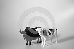 Two decorative figurines of a bull and a cow on a white background. Christmas and New Year concept