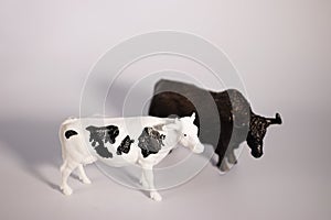 Two decorative figurines of a bull and a cow on a white background. Christmas and New Year concept