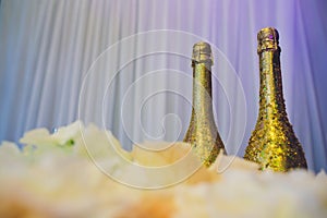 Two decorative gold bottles of luxury champagne with copyspace for your New Year, Christmas or wedding greeting or