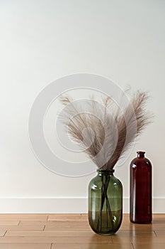 Two decorative vases on wooden floor