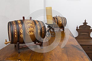 Two decorative wine barrels on a shelf