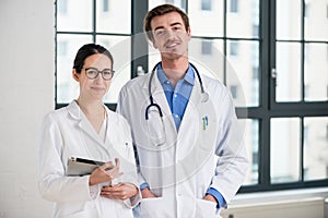 Two dedicated doctors smiling at camera