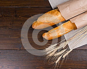 Two delectable bread loaves and dried wheat plants