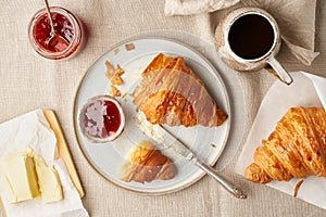 Two delicious croissants and hot drink in mug. Morning French breakfast