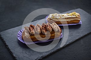 Two delicious eclair cakes - tiramisu and pistachio flavoured