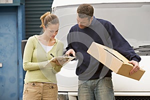 Two delivery people standing infront of van