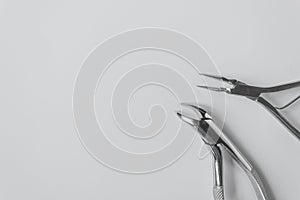 Two dental extraction forceps isolated on the white background. For removing the sick tooth and tooth root.