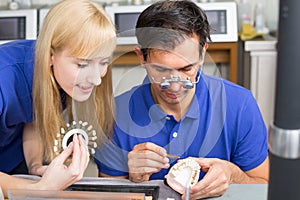 Two dental technicians choosing colour