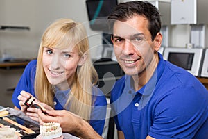 Two dental technicians choosing the right colour