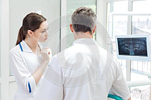 Two dentists discussing treatment