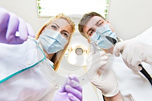 Two dentists examining teeth