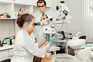 Two dentists treat a patient. Professional uniform and equipment of a dentist. Healthcare Equipping a doctors workplace