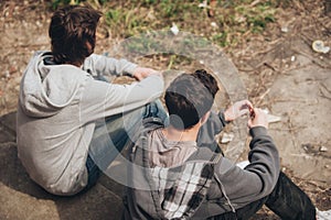 Two depressed and sad young buddies friends thinking about problems photo