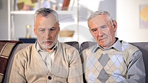 Two desperate old men looking thoughtful, problem depression, old age crisis