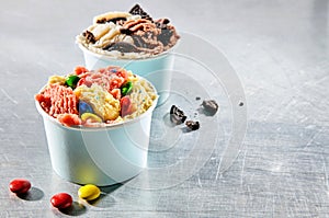 Two dessert containers filled with tasty ice cream photo