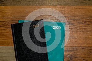 Two diaries isolated on a wood background