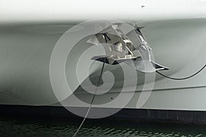 Two different anchors, plow type and another spade type mounted on the bow of modern sailing catamaran